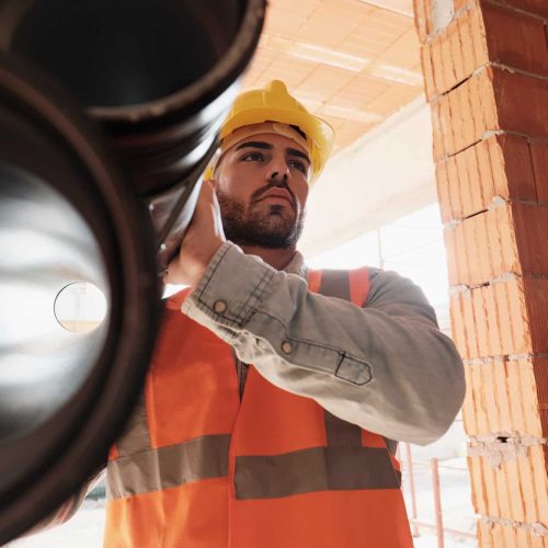 Portrait Of Young Man Working In Construction Site